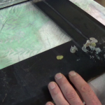 Scraping-off-old-heat-proof-glue-from-cooker-oven-door